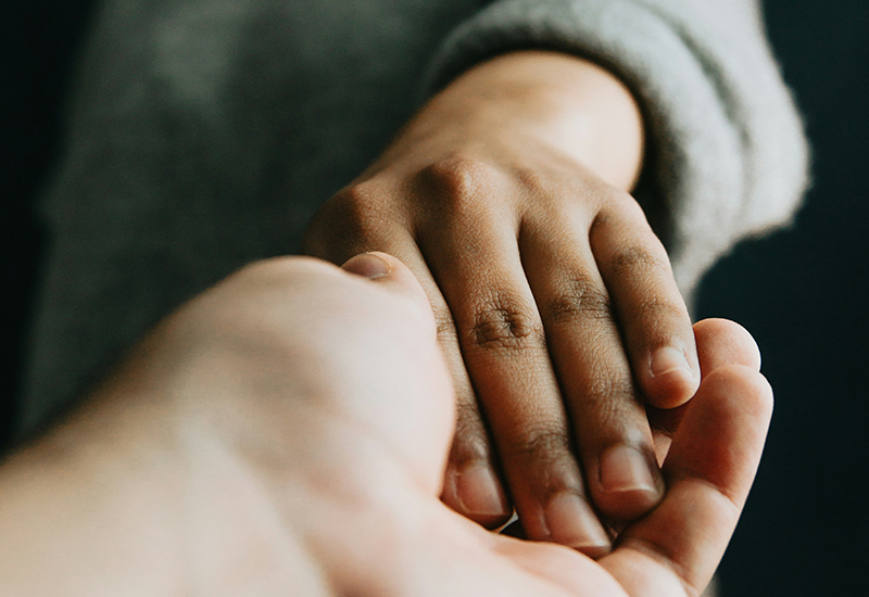 Black and white caring hands